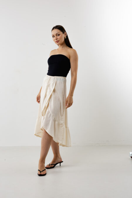 Natural cream cotton midi skirt featuring a unique asymmetric side-ruffle and slit.