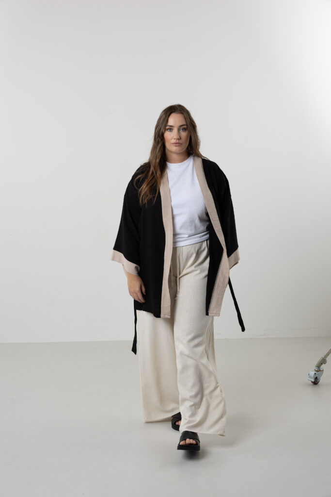 Artisanal abstract face embroidered muslin wrap kimono; unisex line-art cotton duster for sustainable resort wear, travel, and modern bohemian style.