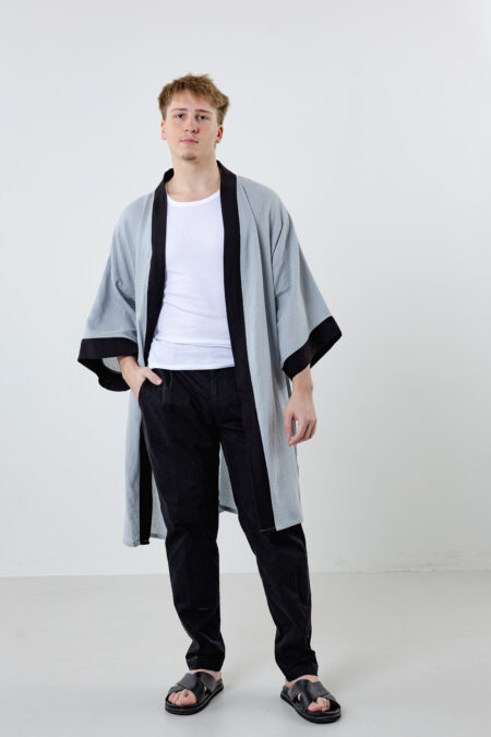 Artisanal abstract face embroidered muslin wrap kimono; unisex line-art cotton duster for sustainable resort wear, travel, and modern bohemian style.