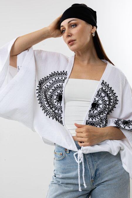 Artisanal mandala embroidery muslin crop blouse; white handcrafted cotton top for sustainable resort wear, travel, and bohemian style.