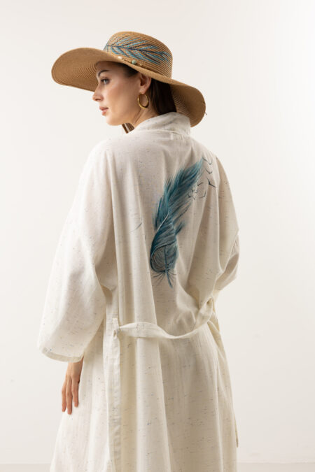 Blue feather hand-painted speckled linen long kimono; artisanal textured wrap dress for sustainable resort wear, travel, and bohemian luxury.