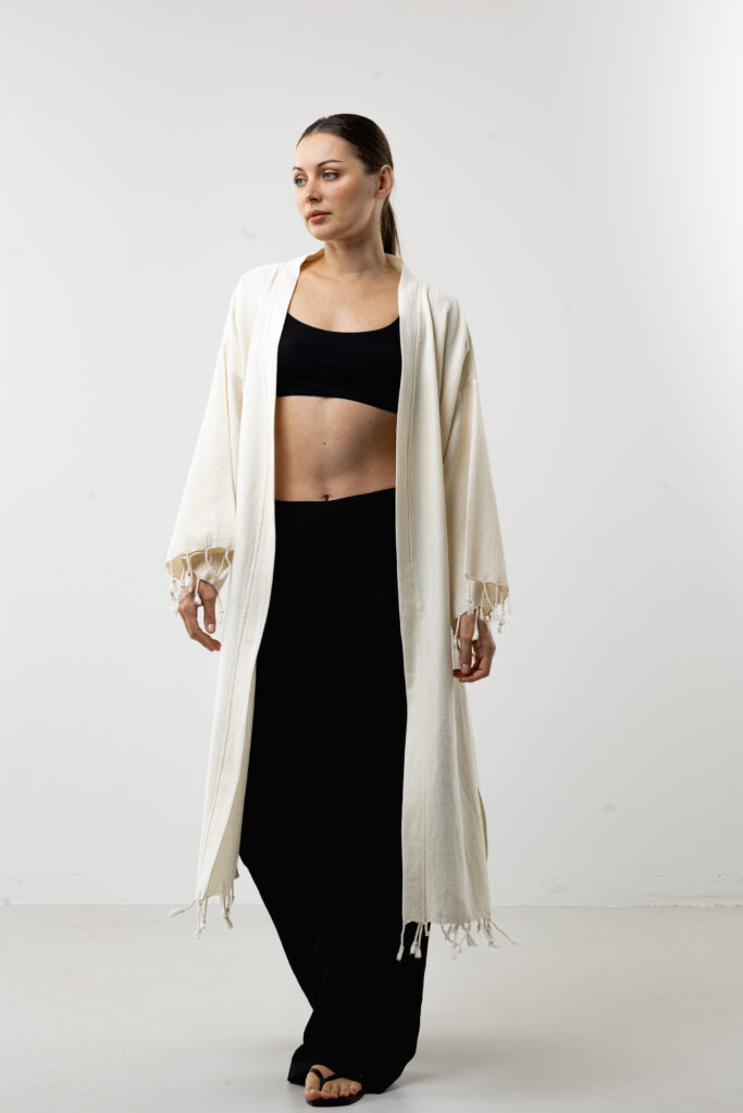 Hand-painted black feather wrap long kimono; bohemian natural cotton robe and dress for sustainable resort wear, travel, and all-season style.