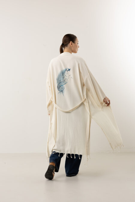 Bohemian hand-painted blue feather wrap kimono; artisanal speckled linen duster for sustainable resort wear, travel, and coastal luxury style.
