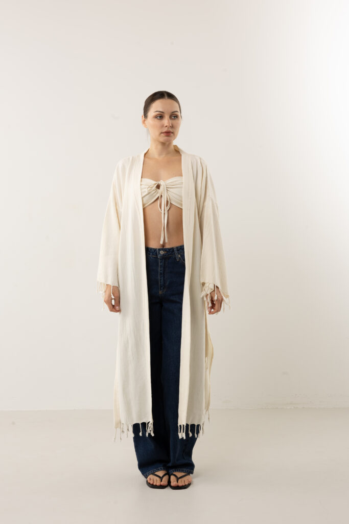 Bohemian hand-painted blue feather wrap kimono; artisanal speckled linen duster for sustainable resort wear, travel, and coastal luxury style.