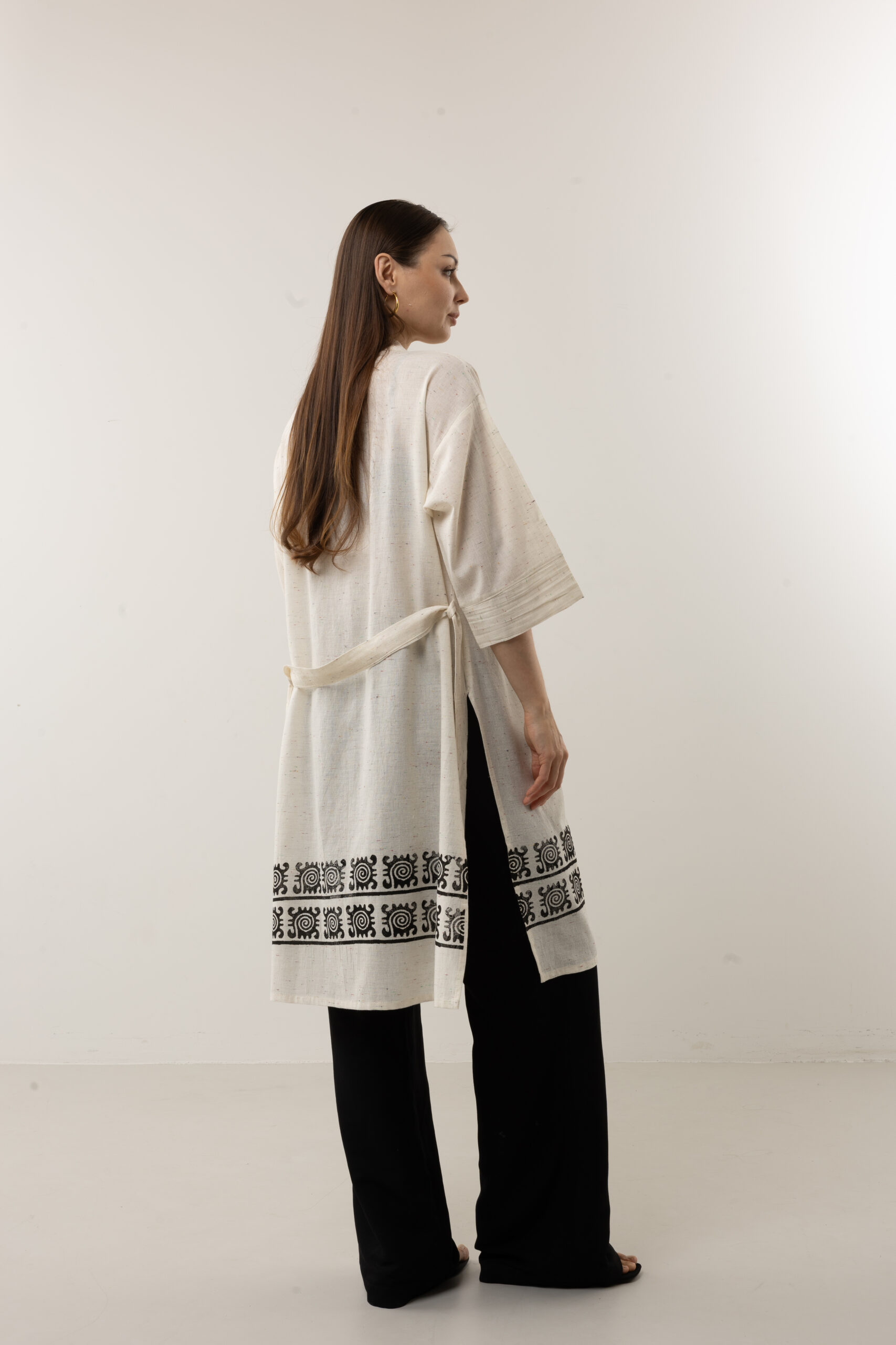 Celestial symbol tunic kimono styled as a high-end resort wear piece.