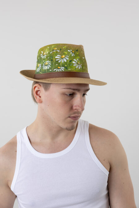 Close-up of hand-painted abstract floral art on straw fedora hat