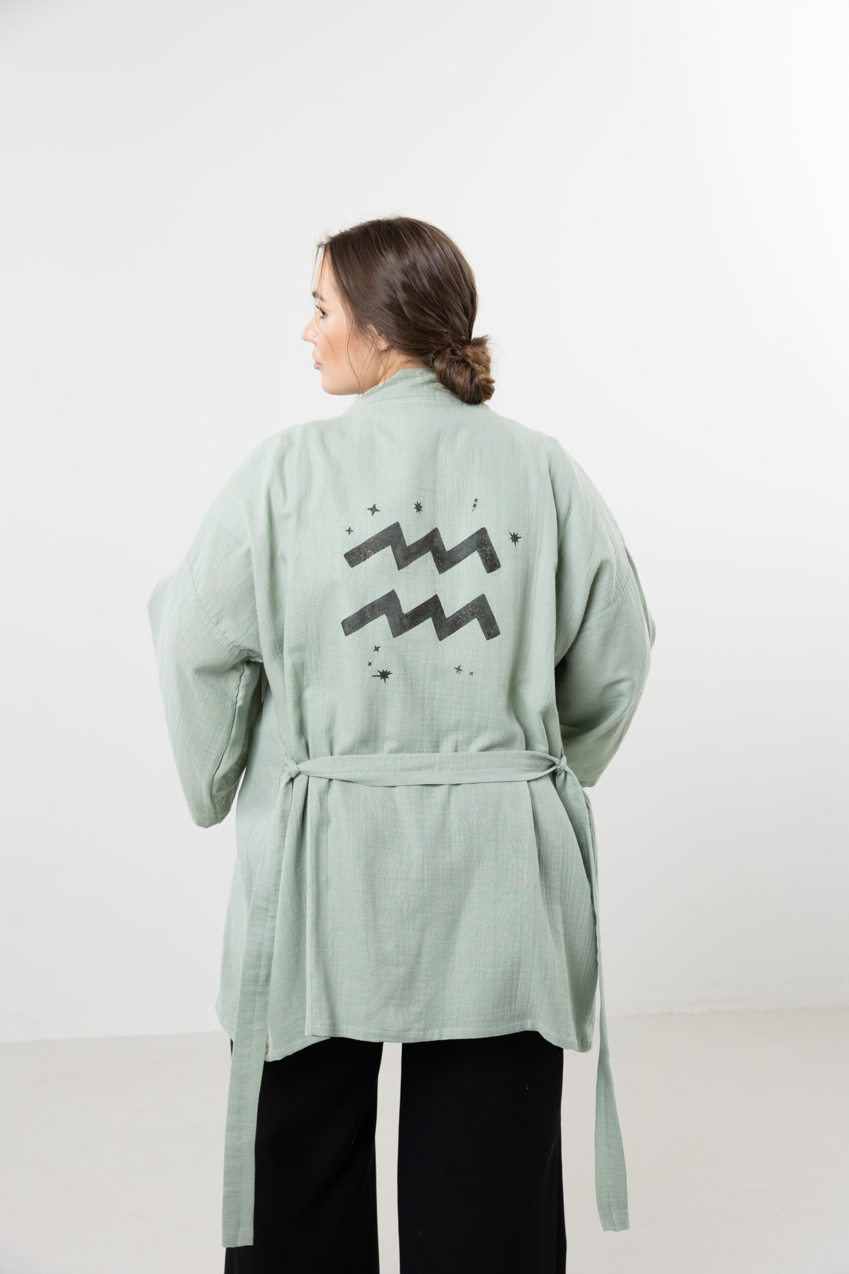 Hand-painted zodiac mini muslin kimono; multi-color naturally dyed jacket with black celestial symbols for sustainable resort wear and travel.