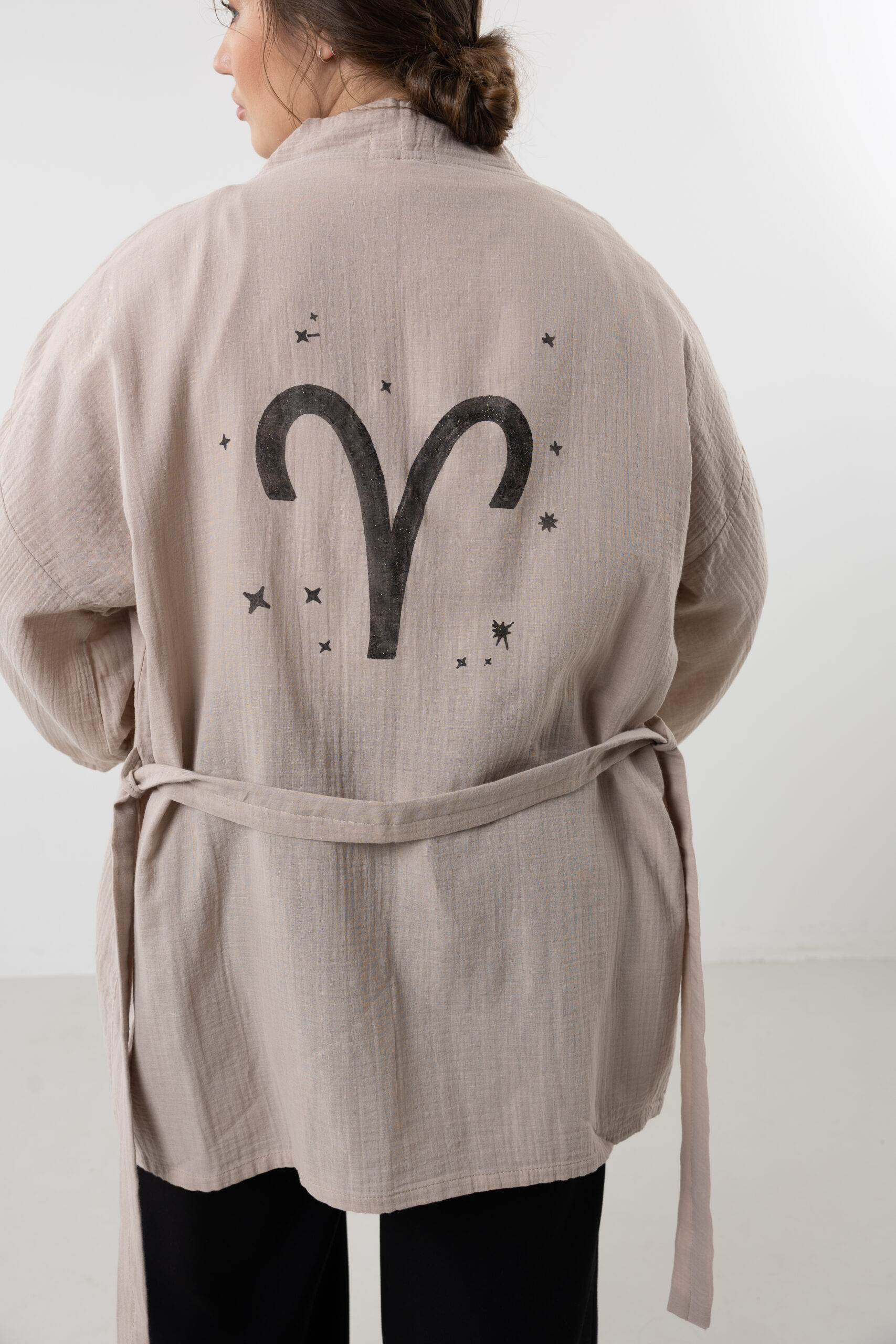 Hand-painted zodiac mini muslin kimono; multi-color naturally dyed jacket with black celestial symbols for sustainable resort wear and travel.