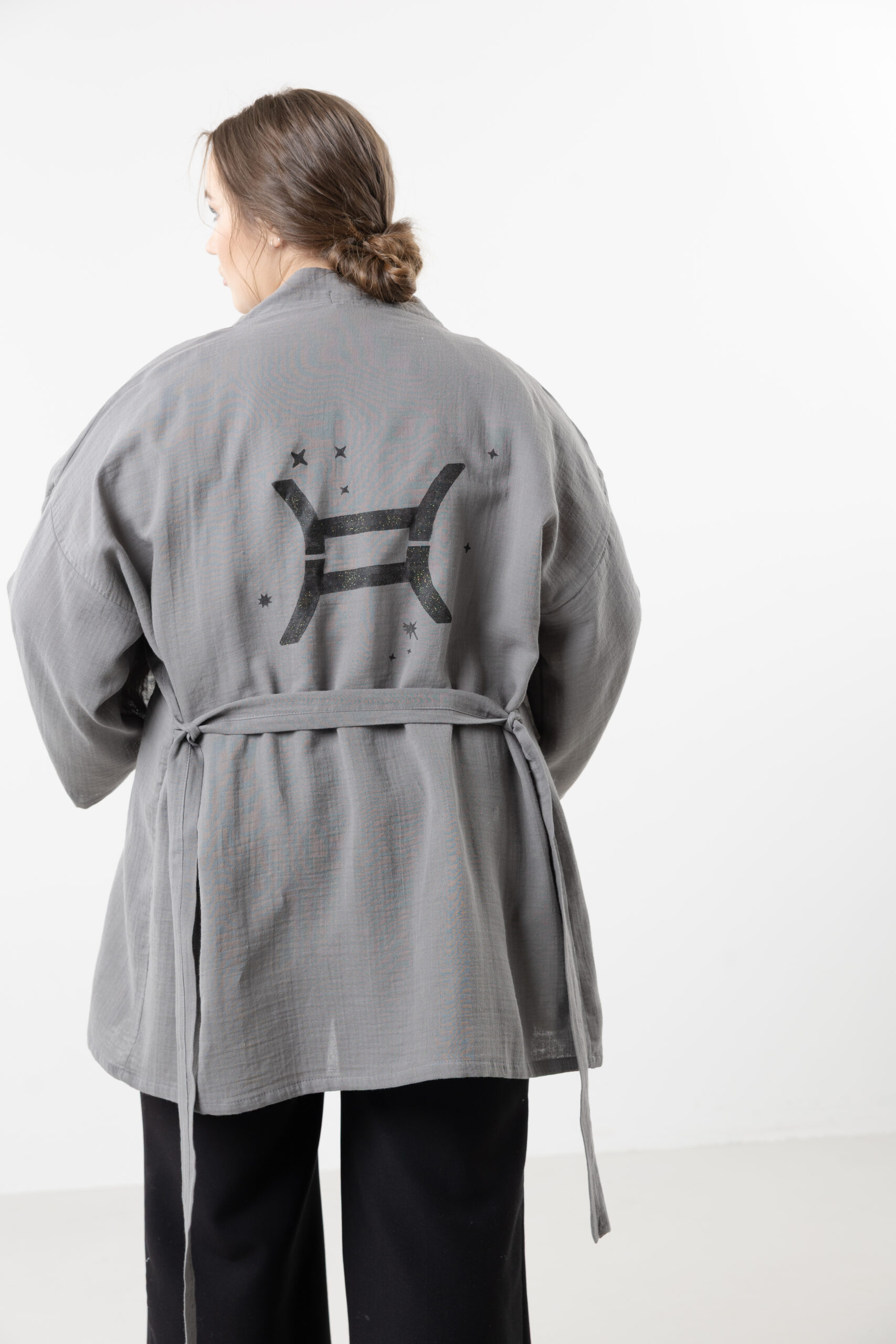 Hand-painted zodiac mini muslin kimono; multi-color naturally dyed jacket with black celestial symbols for sustainable resort wear and travel.