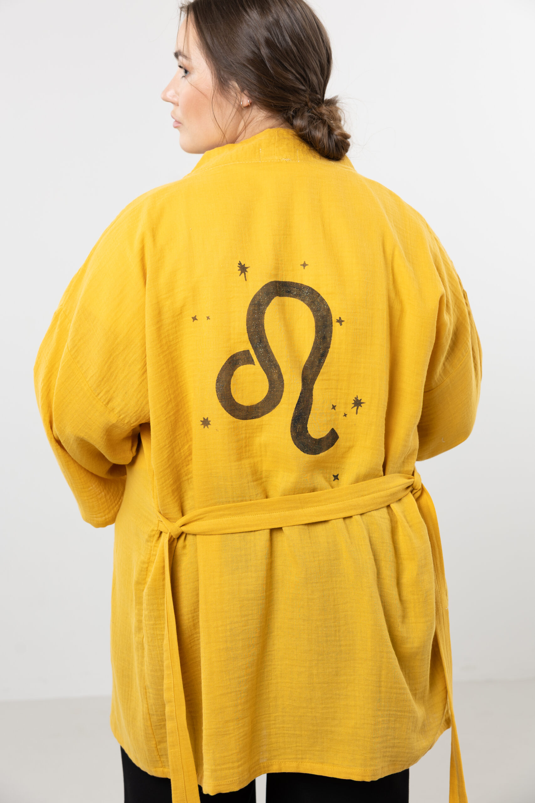 Hand-painted zodiac mini muslin kimono; multi-color naturally dyed jacket with black celestial symbols for sustainable resort wear and travel.