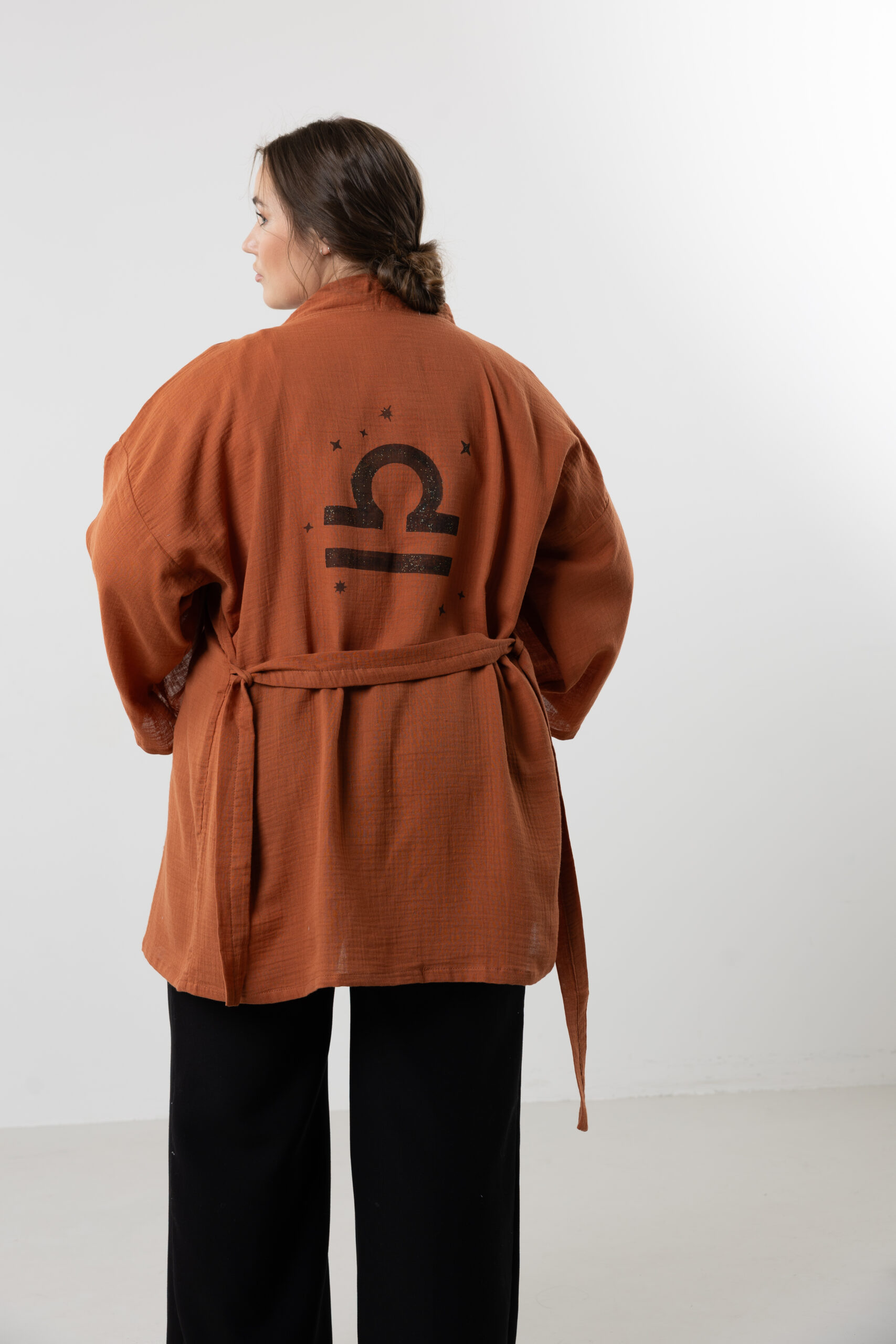 Hand-painted zodiac mini muslin kimono; multi-color naturally dyed jacket with black celestial symbols for sustainable resort wear and travel.