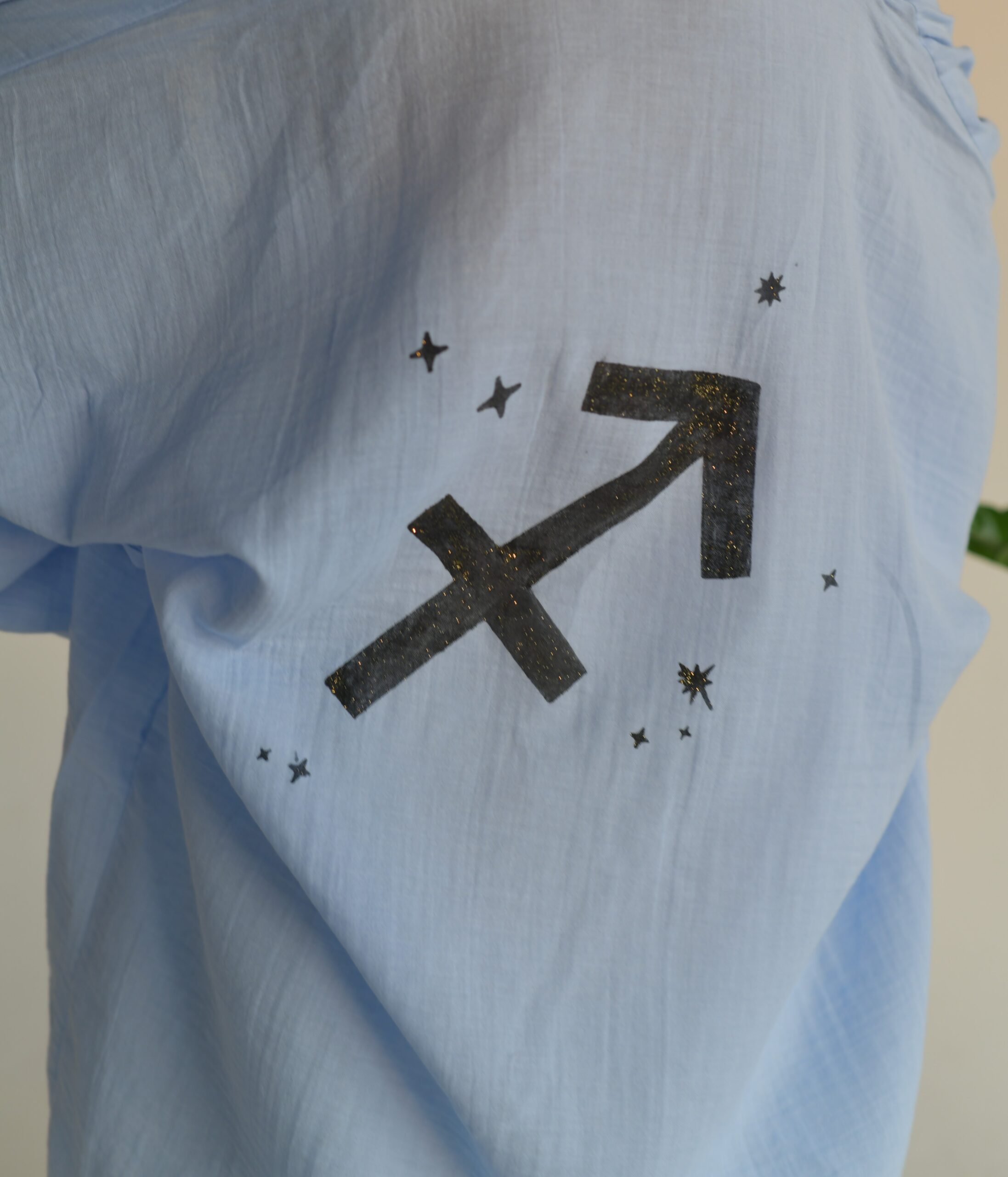 Hand-painted zodiac mini muslin kimono; multi-color naturally dyed jacket with black celestial symbols for sustainable resort wear and travel.