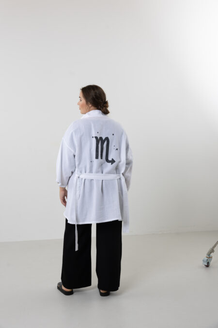 Hand-painted zodiac mini muslin kimono; multi-color naturally dyed jacket with black celestial symbols for sustainable resort wear and travel.