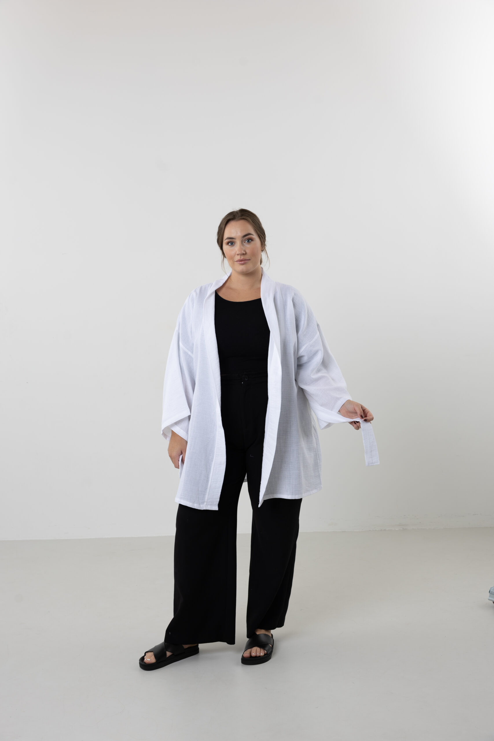 Hand-painted zodiac mini muslin kimono; multi-color naturally dyed jacket with black celestial symbols for sustainable resort wear and travel.