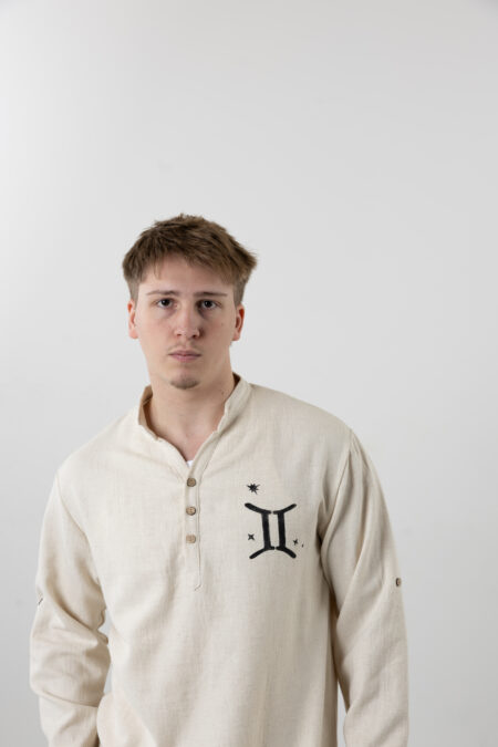 Man wearing a hand-painted Gemini zodiac linen shirt for a creative summer look.