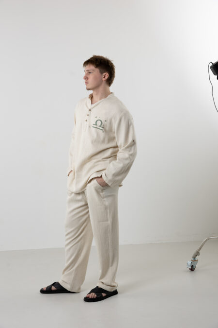 Man wearing a unique hand-painted Libra zodiac shirt for a sophisticated summer look.