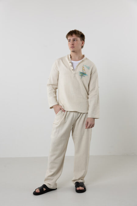 Close-up of hand-painted sail boat art and linen-cotton fabric texture.