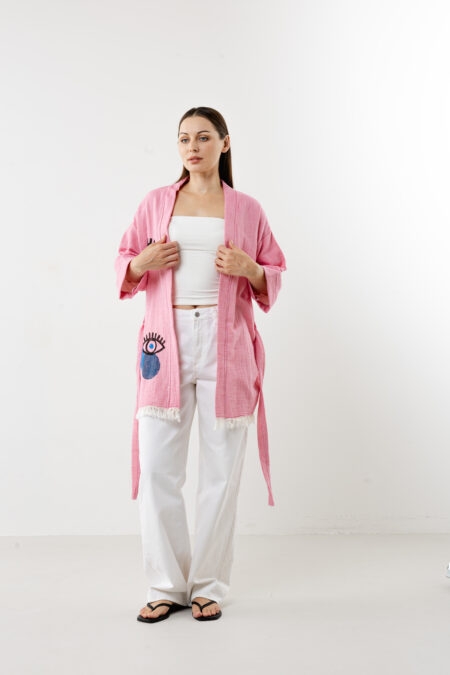 Short pink artisanal cotton kimono with a lucky eye woodblock print and waist tie.