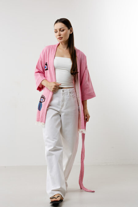 Pink short lucky eye kimono styled over a summer dress for a bohemian look.
