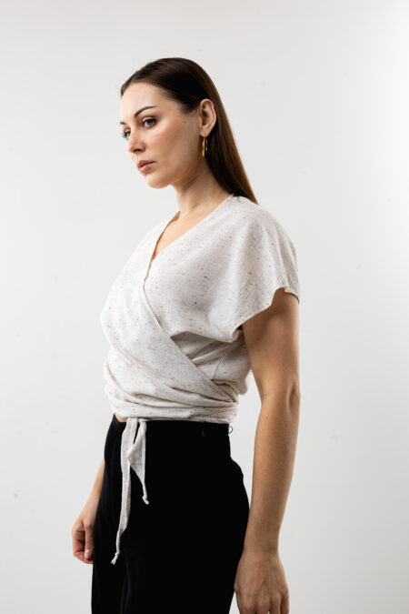 Speckled linen wrap tie-front crop blouse; hand-printed woodblock design, sustainable bohemian top for resort wear and summer travel.