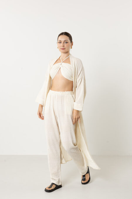 Sophisticated styling of a long cream silk kimono as a luxury duster coat.