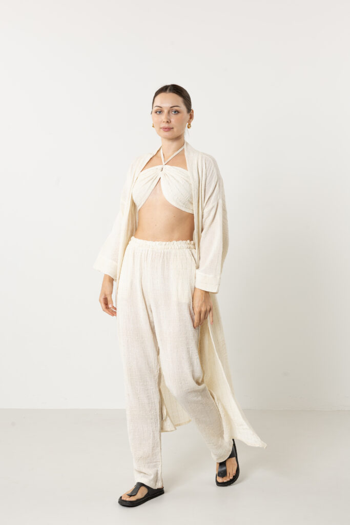 Sophisticated styling of a long cream silk kimono as a luxury duster coat.