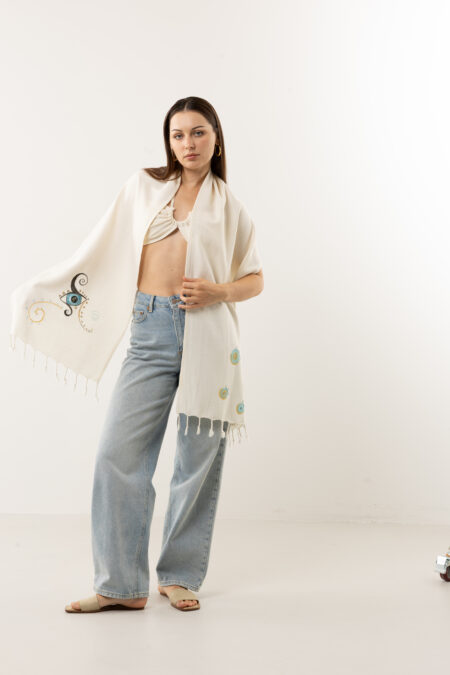 Close-up of artisan brushstrokes and soft cotton texture on lucky eye shawl.