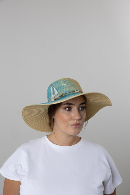 Women’s summer straw hat with hand-painted sailing and nautical motifs.