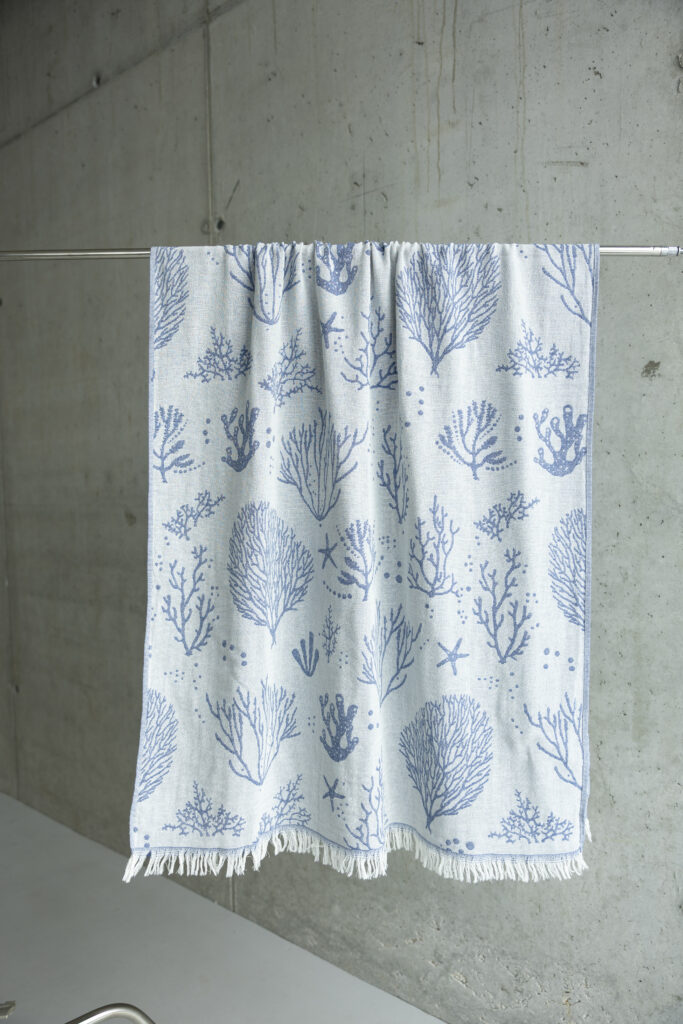 Close-up of coral weave detail on premium Turkish peshtemal